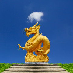 Golden dragon statue and blue sky.