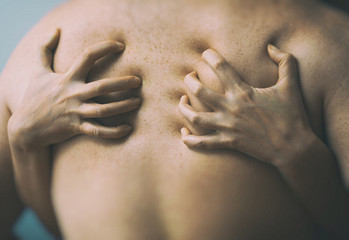 Couple in passion. Female hands on male back.