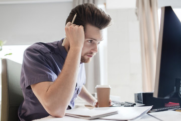 creative male office worker with coffee thinking