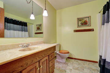 Bathroom vanity with marble counter top and mirror.