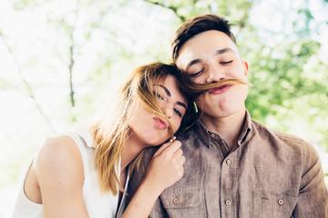 guy doing mustache of girl's hair