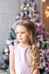 Little cute girl near christmas tree