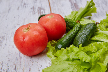 Salad, tomato and cucumber on rustic table