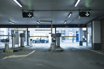 Exit gates with payment machine in parking garage.