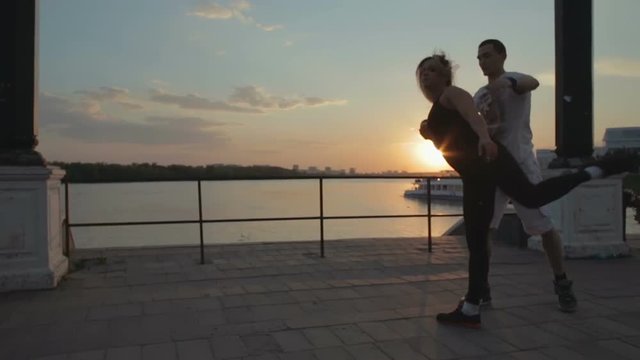 Girl and men dancing strip plastic at sunset stock footage video