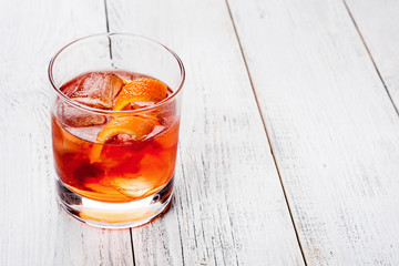 Negroni on a wooden board, white background