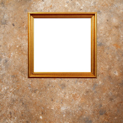 Gold wooden frame on the old wall.