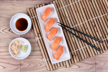 Japanese food - salmon sushi served with side dish.