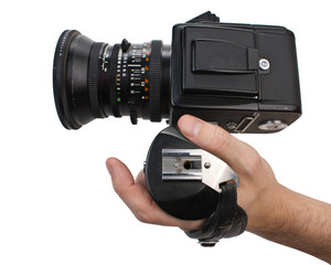 hand holds the handle of the camera