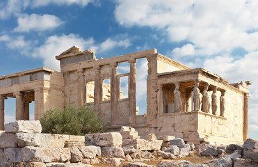 Fototapeta na wymiar Ancient Greek Acropolis. West Erechtheion temple facade with olive trees and Porch of the Caryatids (421-406 years BC. E.) Athens, Greece