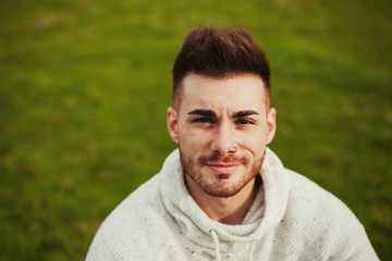 Fototapeta premium Attractive guy with beard in the meadow