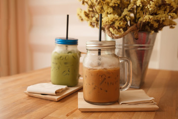 Ice coffee glass on wood table. Vintage tone.