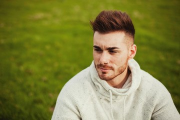 Attractive guy with beard in the meadow