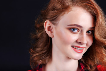 Portrait of beautiful girl. Freckled woman with wavy red hair an