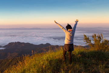 freedom woman on top of mountain with flowing mist and beautiful