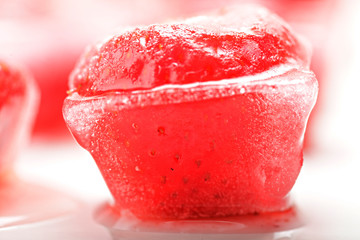 Strawberry in ice cube closeup