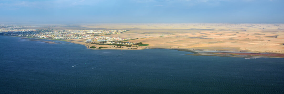 The coast in Namibia and panorama of the city Walvis Bay i