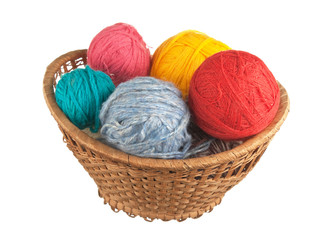 ball of wool and knitting needles in basket isolated on a white  background