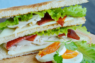 Breakfast menu simple.
Sandwich and boiled egg on wooden board.
