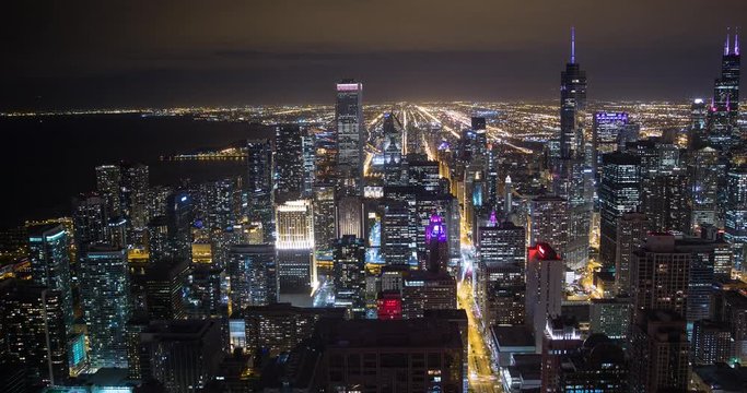 Chicago, Illinois, USA - view from John Hancock Center of City with Willis Tower (Sears Tower), Tribune Tower and NBC Tower facing south at night - Timelapse with pan left to right