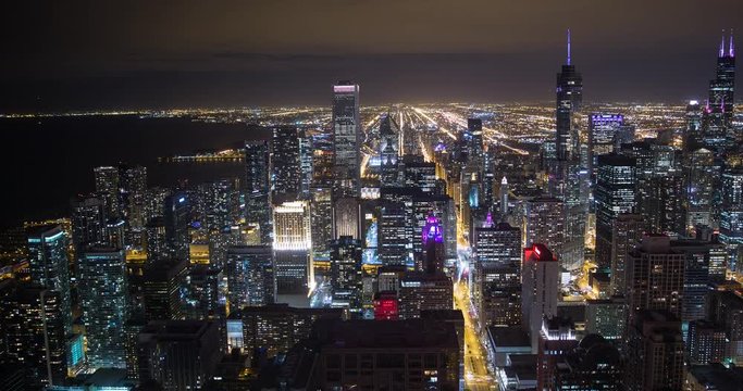 Chicago, Illinois, USA - view from John Hancock Center of City with Willis Tower (Sears Tower), Tribune Tower and NBC Tower facing south at night - Timelapse with pan left to right
