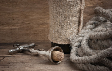 Old corkscrew and bottle of wine