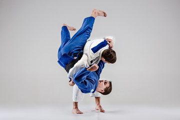 The two judokas fighters fighting men