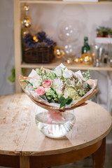 glass vase with Mixed bouquet on wood table. beautiful fresh flowers still life.