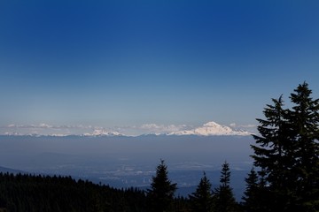 A beautiful landscape shot with snow capped mountains near the Grouse Mountain area in Canada