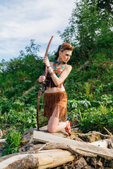 Young beautiful amazon girl hunting in the forest