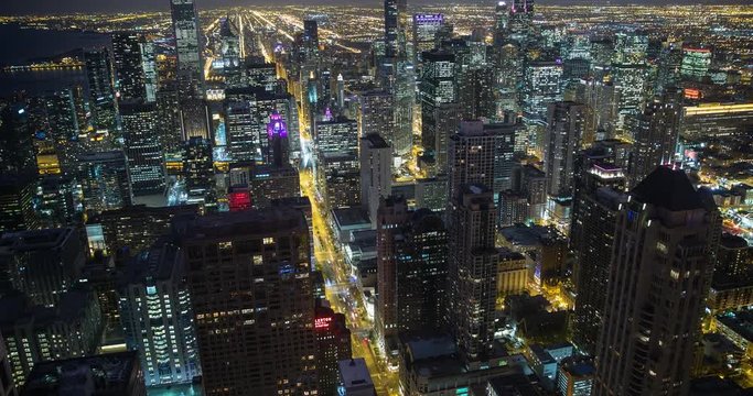 Chicago, Illinois, USA - view from the observatory of the John Hancock Center of illuminated City facing south at night - Timelapse with zoom in 