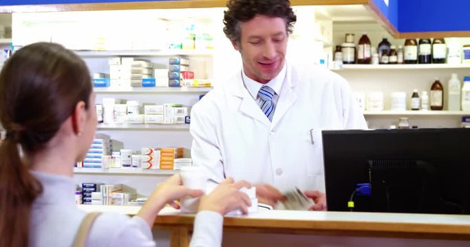 Pharmacist receiving payment from customer