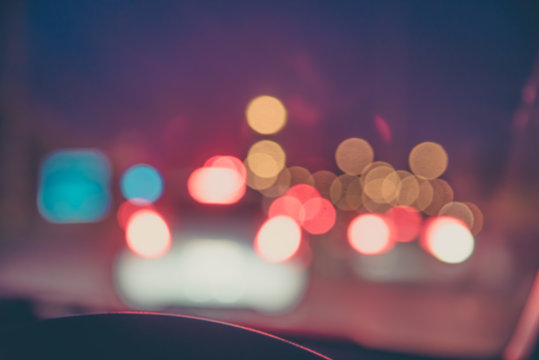 blur image of people driving car on night time.