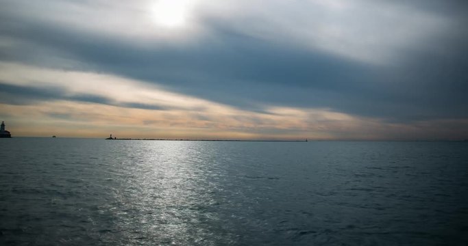 Chicago, Illinois, USA - view from Navy Pier facing Lake Michigan with lighthouse and boats after sunrise - Timelapse with zoom in