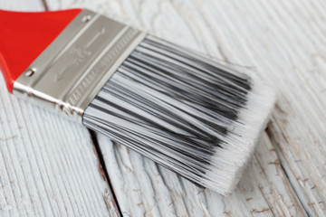 Paint brush on a white wooden board