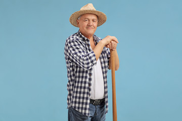 Mature farmer posing on blue background