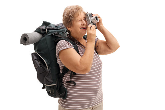 Senior hiker taking a picture with a camera