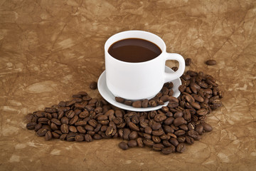 cup with hot coffee and grains