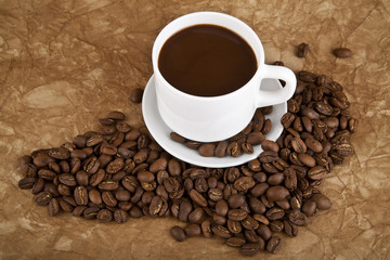 cup with hot coffee and grains