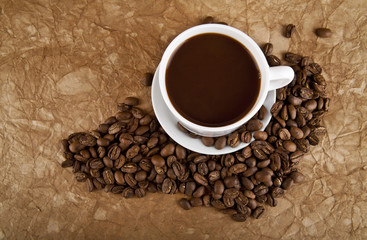 cup with hot coffee and grains