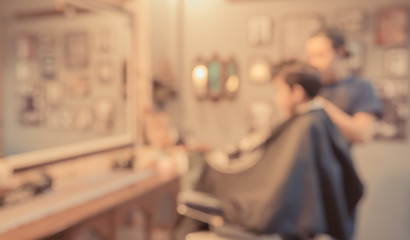   blur image of young asia boy at barber shop.