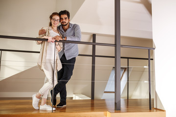 Young couple standing in they new home.Moving house.