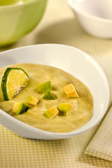 Avocado soup in a white bowl 