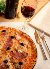 Pizza and wine on a restaurant table
