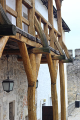 Fototapeta na wymiar Fragment of a wooden balcony in old fortress