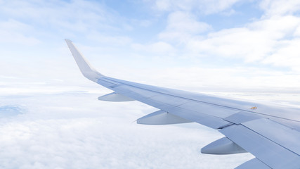 Wing of airplane fly over  the blue sky and white cloud 2