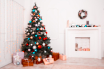 Beautiful new year room with decorated Christmas tree, gifts and fireplace. The idea for postcards. Soft focus. Shallow DOF