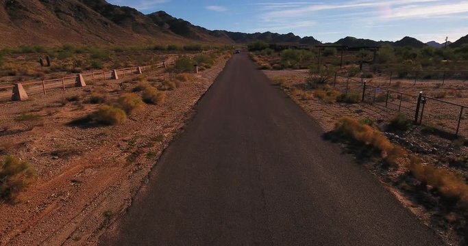 An Aerial View Of A Pickup Truck Traveling On A Typical Arizona Desert Road.  	