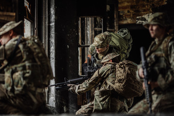 Soldiers on patrol in destroyed city. Military and rescue operation