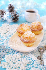 Obraz na płótnie Canvas Christmas coffee break: muffins, cup of coffee and illuminated g